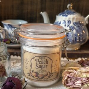 Peach sugar jar with floral decorations.